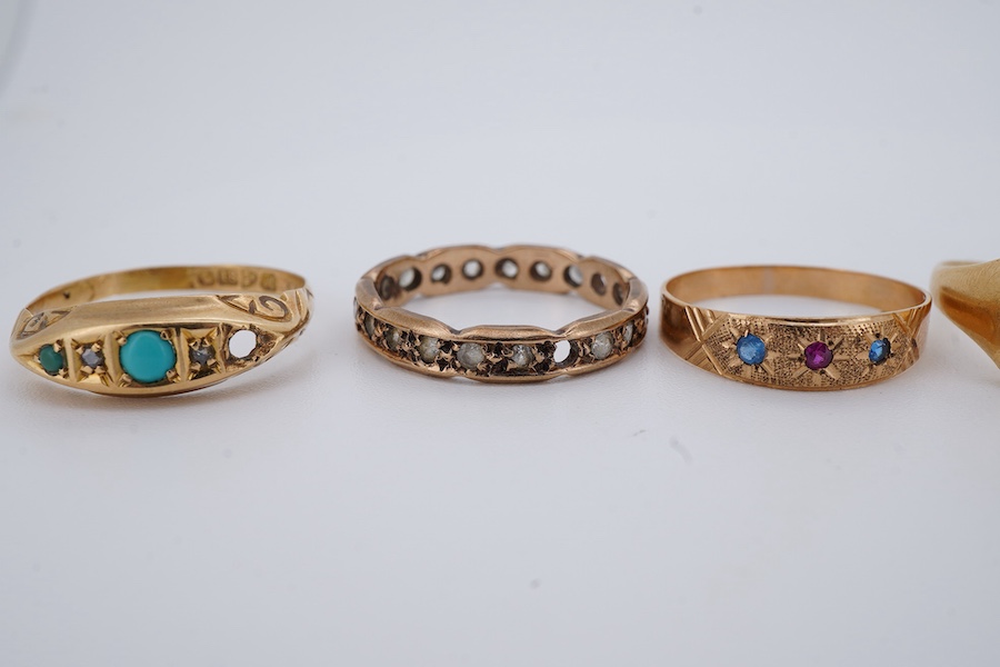 Five gold rings, comprising: an 18ct gold and turquoise ring, British hallmarks; a paste eternity ring; a synthetic sapphire and synthetic ruby ring; and a signet ring, faintly engraved, combined gross weight approximate